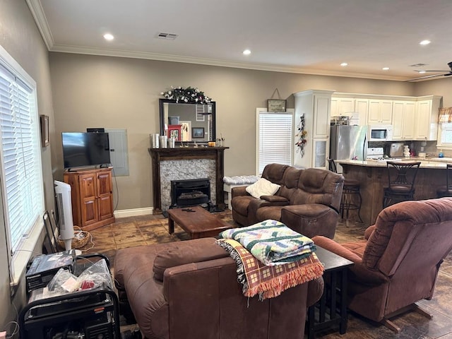 17308 Magnino Rd, Shawnee, OK 74801 - living area with ornamental molding, a stone fireplace, recessed lighting, ceiling fan, and baseboards