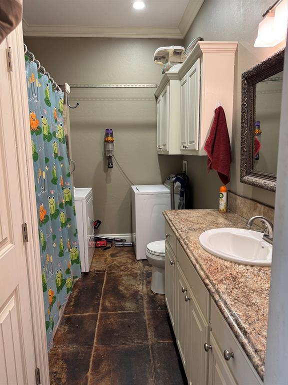 17308 Magnino Rd, Shawnee, OK 74801 - full bath with washer and dryer, toilet, ornamental molding, vanity, and a shower with curtain