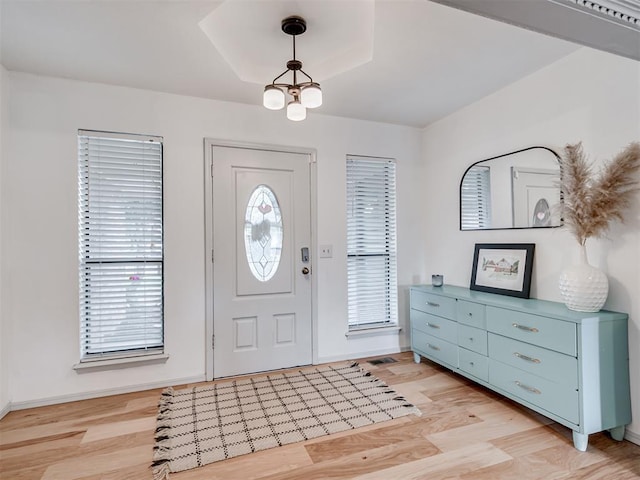 209 E Platt Dr, Yukon, OK 73099 - foyer entrance featuring healthy amount of natural light, light wood-type flooring, a chandelier, and baseboards