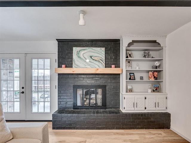 209 E Platt Dr, Yukon, OK 73099 - living area featuring plenty of natural light, wood finished floors, french doors, and a brick fireplace