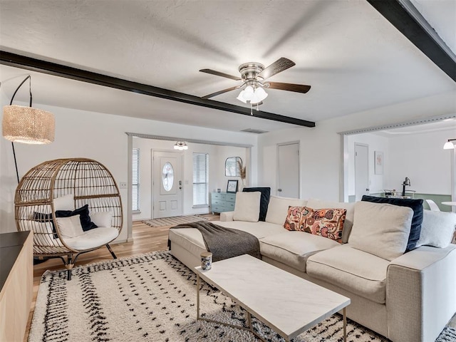 209 E Platt Dr, Yukon, OK 73099 - living room featuring beam ceiling, a ceiling fan, and light wood-type flooring