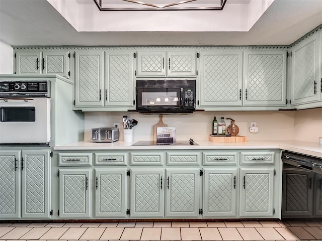 209 E Platt Dr, Yukon, OK 73099 - kitchen featuring black appliances, light countertops, and light tile patterned floors