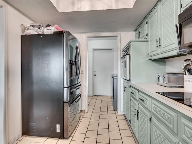 209 E Platt Dr, Yukon, OK 73099 - kitchen featuring black appliances, light countertops, and light tile patterned floors
