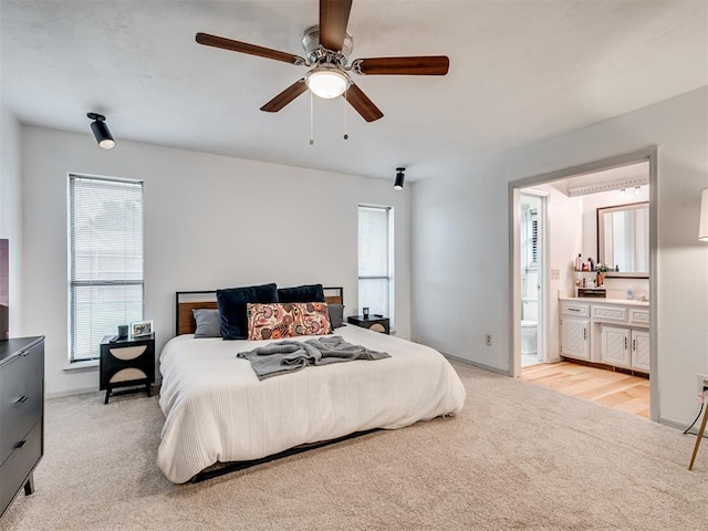 209 E Platt Dr, Yukon, OK 73099 - bedroom featuring light carpet, multiple windows, connected bathroom, and ceiling fan
