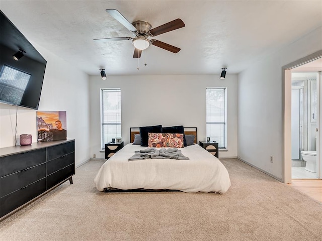 209 E Platt Dr, Yukon, OK 73099 - bedroom with light colored carpet, a ceiling fan, and ensuite bath