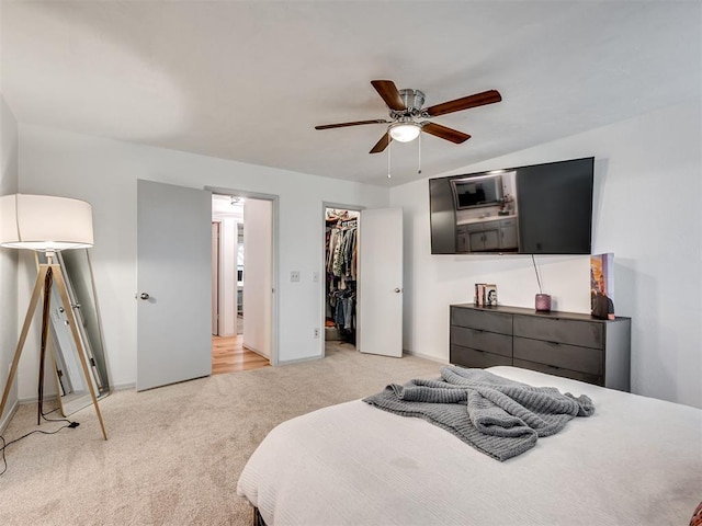 209 E Platt Dr, Yukon, OK 73099 - bedroom with light colored carpet, a spacious closet, baseboards, and ceiling fan