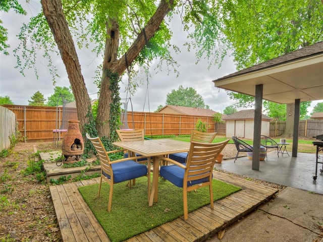 209 E Platt Dr, Yukon, OK 73099 - fenced backyard featuring a fire pit, a patio area, outdoor dining area, and a deck