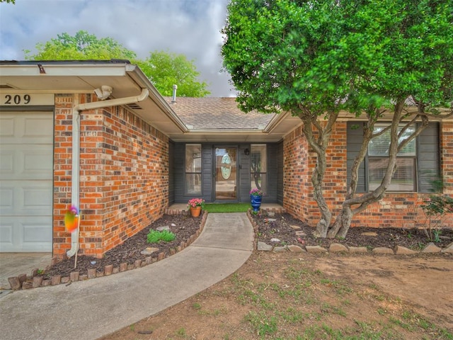 209 E Platt Dr, Yukon, OK 73099 - doorway to property with brick siding and a garage