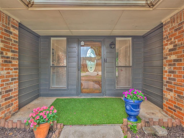 209 E Platt Dr, Yukon, OK 73099 - doorway to property featuring brick siding