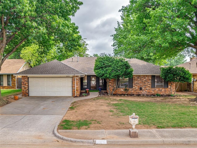209 E Platt Dr, Yukon, OK 73099 - ranch-style home with a garage, driveway, brick siding, and a shingled roof