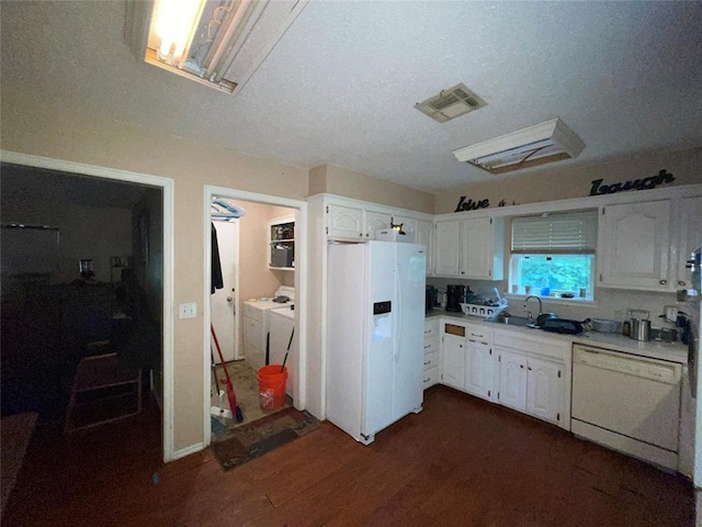 617 Mark Dr, Oklahoma City, OK 73115 - kitchen featuring white appliances, washing machine and dryer, white cabinetry, and a sink