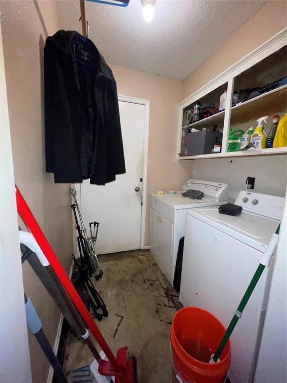 617 Mark Dr, Oklahoma City, OK 73115 - laundry room with washer and dryer and a textured ceiling