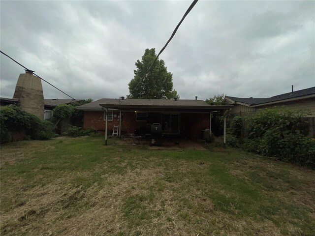 617 Mark Dr, Oklahoma City, OK 73115 - view of green lawn featuring a patio