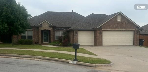 2508 SE 10th Ct, Moore, OK 73160 - view of front of property with a garage, brick siding, and concrete driveway