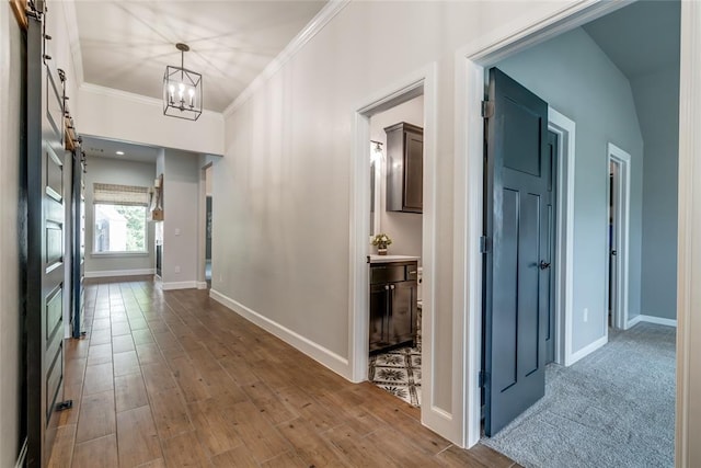 600 NW 186th St, Edmond, OK 73012 - hall with ornamental molding, baseboards, a chandelier, and wood finished floors