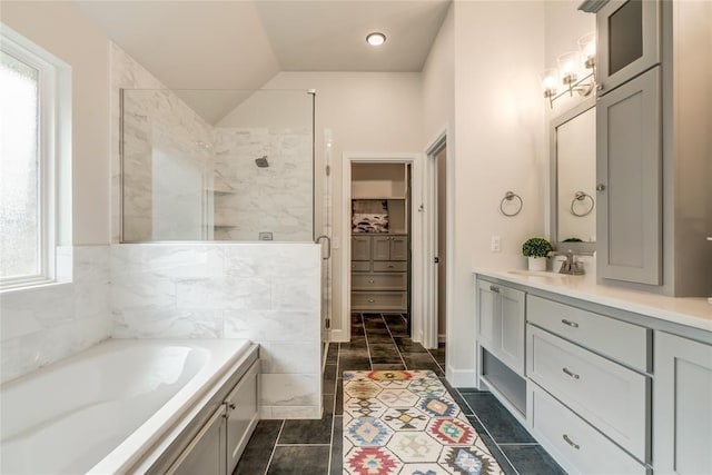 600 NW 186th St, Edmond, OK 73012 - bathroom featuring a shower stall, a bath, vanity, a spacious closet, and lofted ceiling