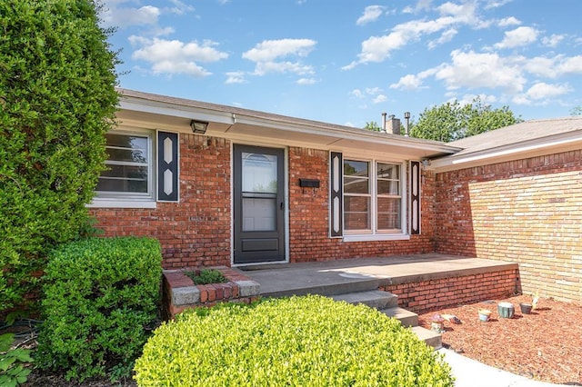 3032 NW 67th St, Oklahoma City, OK 73116 - view of exterior entry featuring brick siding
