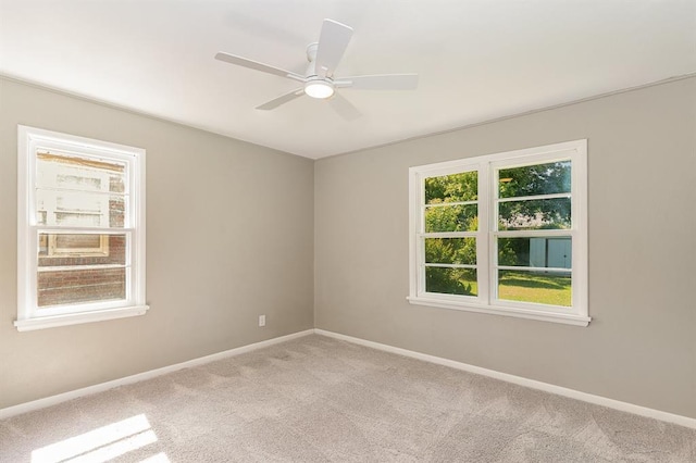3032 NW 67th St, Oklahoma City, OK 73116 - spare room featuring light carpet, baseboards, and ceiling fan