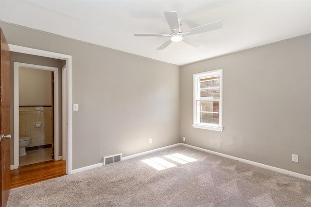 3032 NW 67th St, Oklahoma City, OK 73116 - carpeted empty room featuring ceiling fan, tile walls, and baseboards