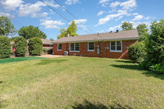 3032 NW 67th St, Oklahoma City, OK 73116 - rear view of house with cooling unit and brick siding