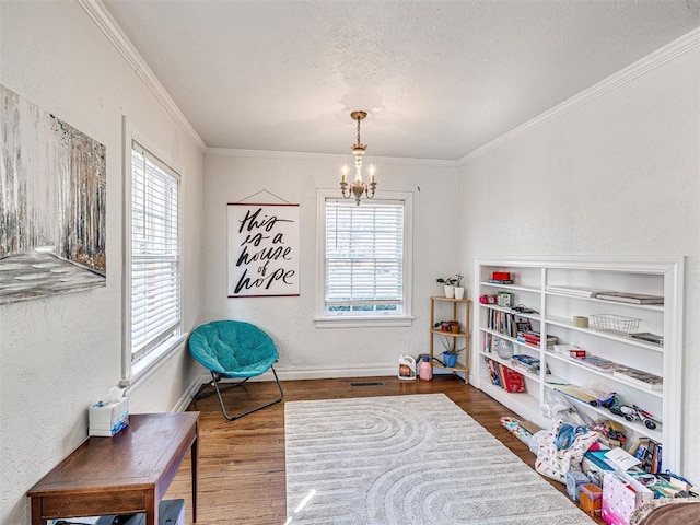 705 Chautauqua Ave, Norman, OK 73069 - living area featuring a chandelier, healthy amount of natural light, wood finished floors, crown molding, and a textured ceiling