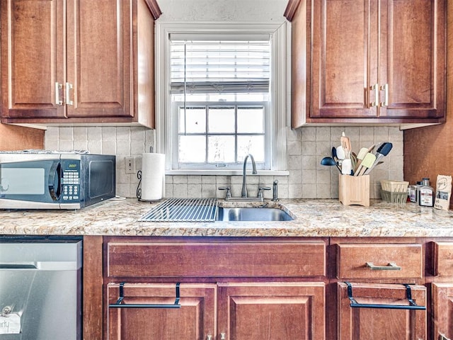 705 Chautauqua Ave, Norman, OK 73069 - kitchen with dishwasher, black microwave, a sink, and backsplash