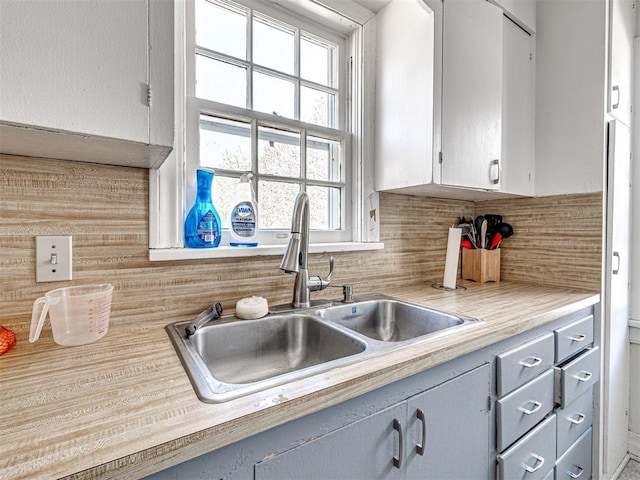 705 Chautauqua Ave, Norman, OK 73069 - kitchen with a sink, light countertops, tasteful backsplash, and plenty of natural light