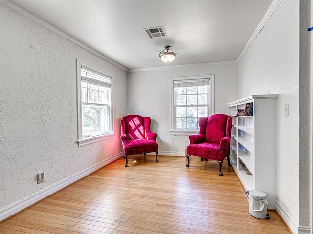705 Chautauqua Ave, Norman, OK 73069 - sitting room with a textured wall, ornamental molding, hardwood / wood-style floors, and baseboards