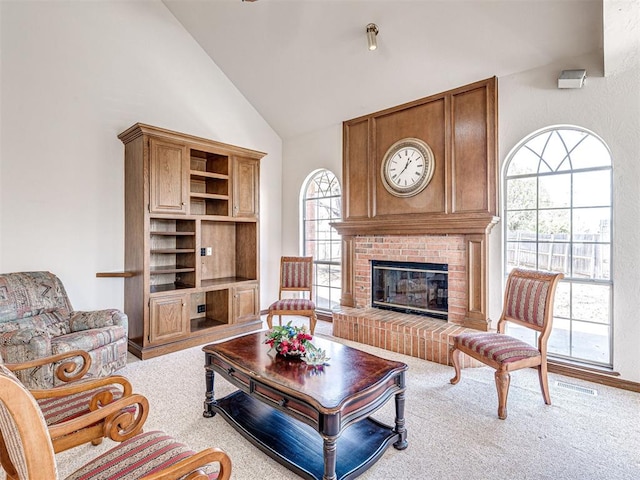 2616 Redvine Rd, Edmond, OK 73034 - carpeted living area featuring high vaulted ceiling and a fireplace