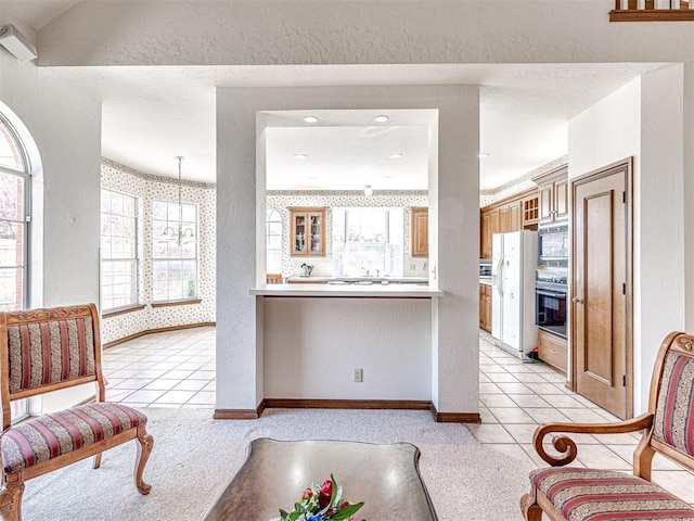 2616 Redvine Rd, Edmond, OK 73034 - living room with baseboards, light tile patterned floors, light carpet, a textured wall, and wallpapered walls
