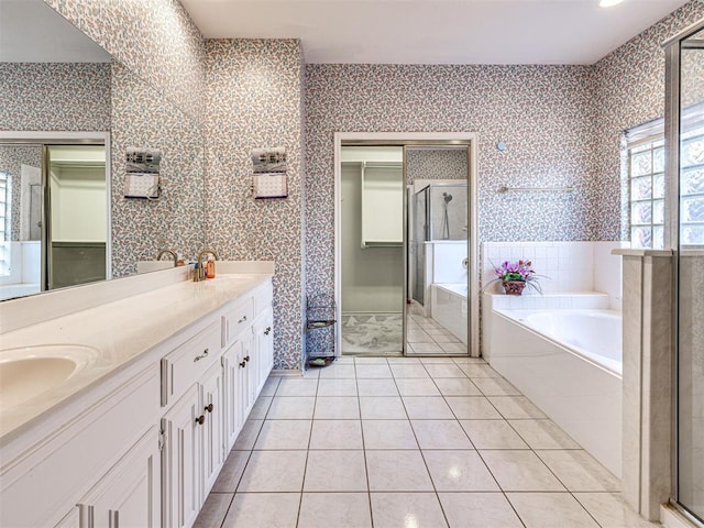2616 Redvine Rd, Edmond, OK 73034 - bathroom featuring wallpapered walls, a shower stall, a garden tub, double vanity, and tile patterned flooring