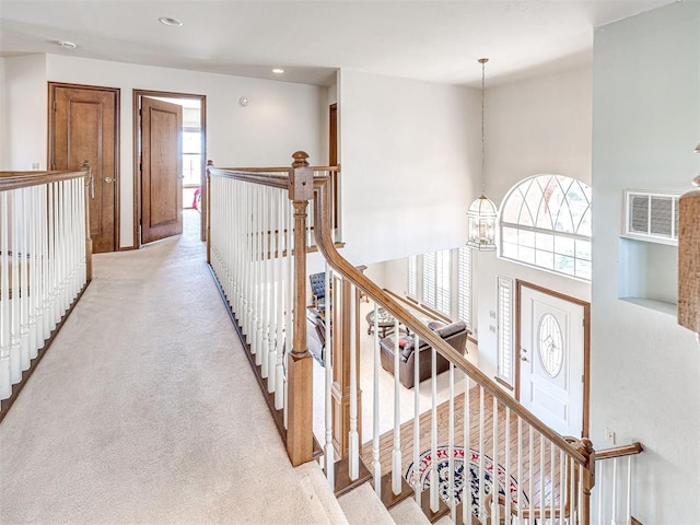2616 Redvine Rd, Edmond, OK 73034 - hallway with a chandelier, light colored carpet, and recessed lighting
