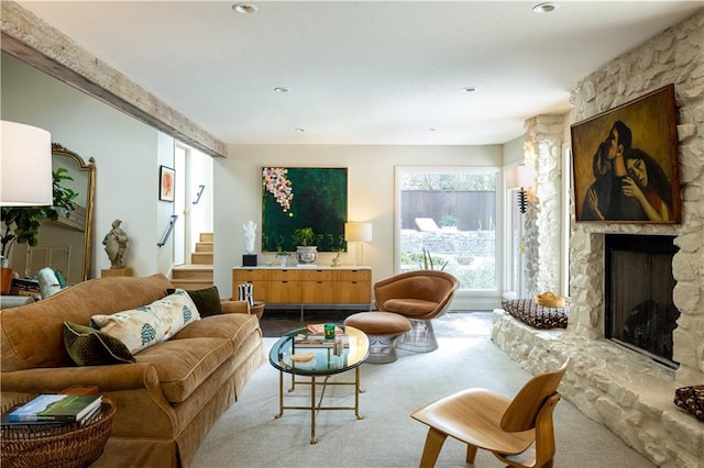 1917 Whispering Pines Cir, Norman, OK 73072 - carpeted living room with a stone fireplace and stairs
