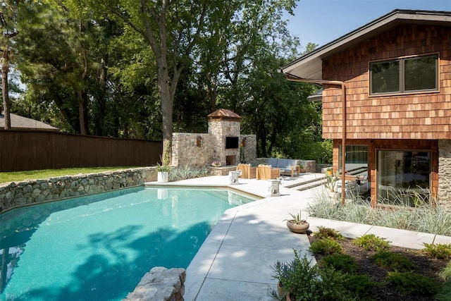 1917 Whispering Pines Cir, Norman, OK 73072 - view of swimming pool featuring a patio area and an outdoor living space with a fireplace
