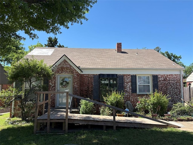 2508 N Cummings Dr, Oklahoma City, OK 73107 - view of front facade featuring brick siding, a wooden deck, a chimney, and roof with shingles