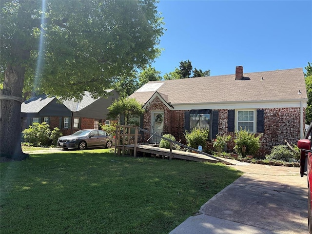 2508 N Cummings Dr, Oklahoma City, OK 73107 - single story home featuring a front lawn, brick siding, and a chimney