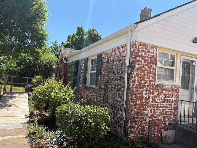 2508 N Cummings Dr, Oklahoma City, OK 73107 - view of home's exterior featuring brick siding and a chimney
