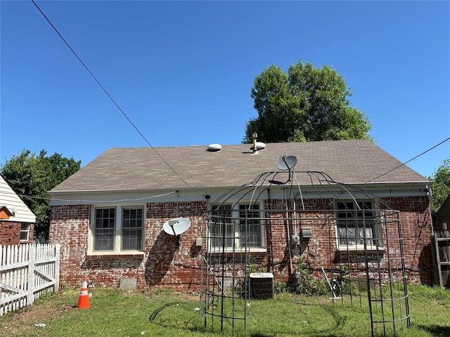 2508 N Cummings Dr, Oklahoma City, OK 73107 - back of property with brick siding, roof with shingles, and central AC unit