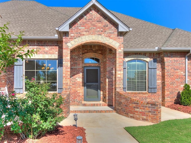 10716 Quail Reserve Rd, Oklahoma City, OK 73173 - property entrance with brick siding and roof with shingles