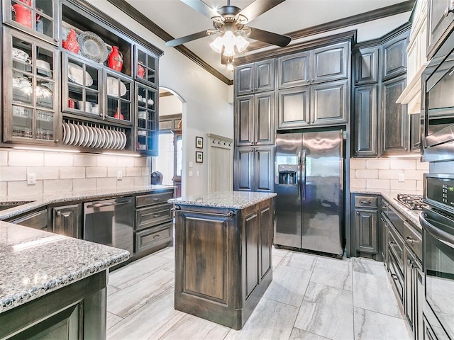 10716 Quail Reserve Rd, Oklahoma City, OK 73173 - kitchen with appliances with stainless steel finishes, ornamental molding, arched walkways, a ceiling fan, and decorative backsplash