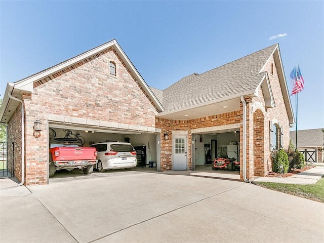 10716 Quail Reserve Rd, Oklahoma City, OK 73173 - view of front facade featuring driveway, brick siding, a garage, and roof with shingles