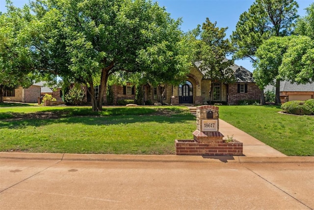 18617 Wolf Creek Dr, Edmond, OK 73012 - view of front facade featuring a front lawn and brick siding