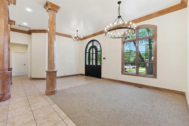 18617 Wolf Creek Dr, Edmond, OK 73012 - foyer with decorative columns, light tile patterned floors, ornamental molding, a chandelier, and plenty of natural light