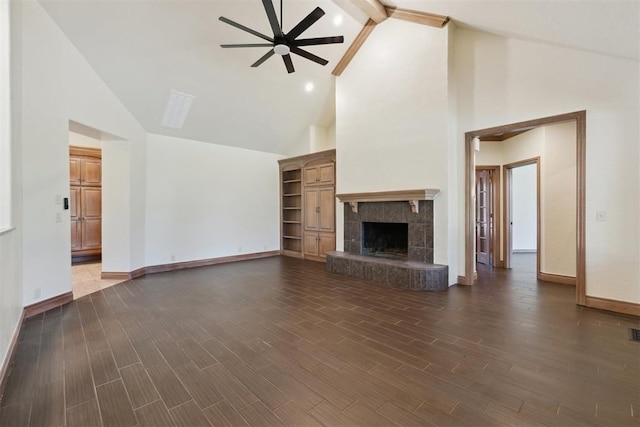 18617 Wolf Creek Dr, Edmond, OK 73012 - unfurnished living room featuring ceiling fan, high vaulted ceiling, beamed ceiling, baseboards, and dark wood-style floors