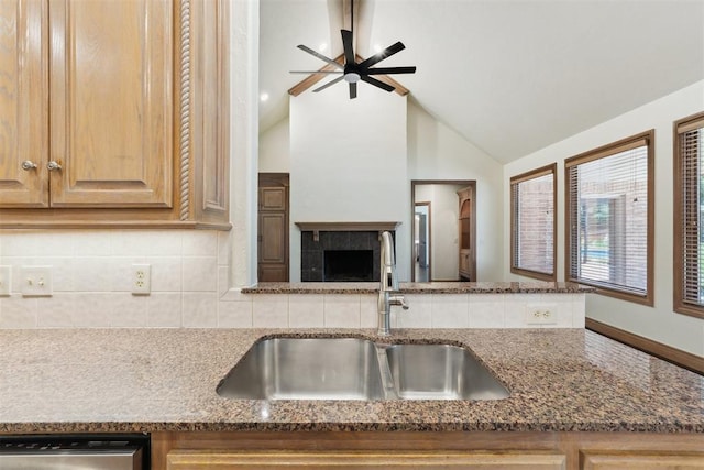 18617 Wolf Creek Dr, Edmond, OK 73012 - kitchen with a sink, dishwasher, dark stone countertops, decorative backsplash, and lofted ceiling