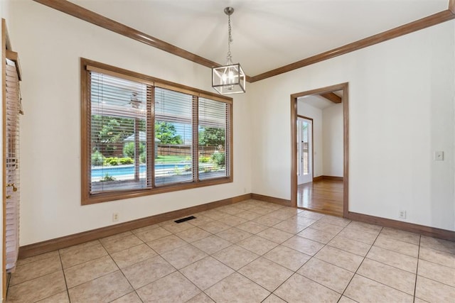 18617 Wolf Creek Dr, Edmond, OK 73012 - spare room featuring a chandelier, ornamental molding, light tile patterned flooring, and baseboards