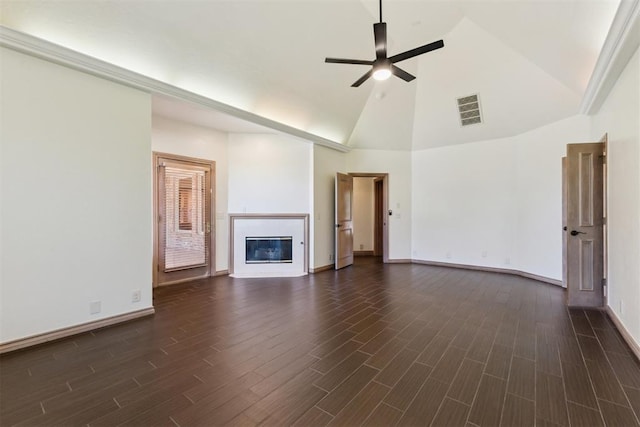 18617 Wolf Creek Dr, Edmond, OK 73012 - unfurnished living room featuring a ceiling fan, high vaulted ceiling, dark wood-type flooring, a glass covered fireplace, and baseboards