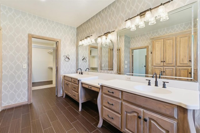 18617 Wolf Creek Dr, Edmond, OK 73012 - full bath with wallpapered walls, vanity, baseboards, and wood finished floors