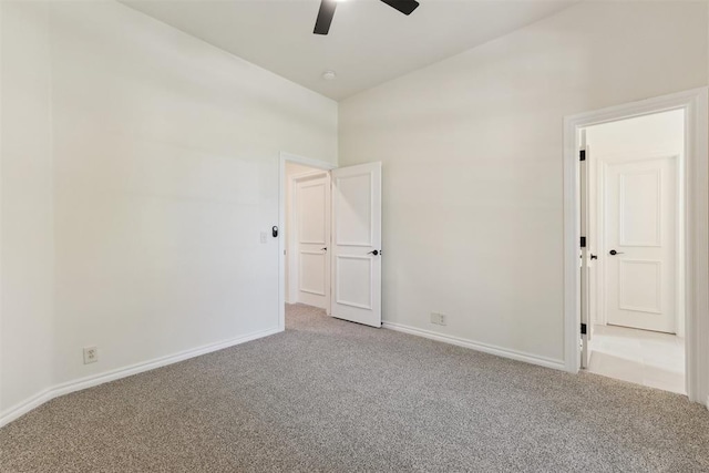 18617 Wolf Creek Dr, Edmond, OK 73012 - unfurnished bedroom featuring carpet flooring, baseboards, vaulted ceiling, and a ceiling fan