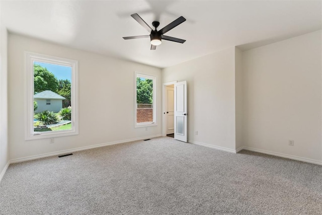 18617 Wolf Creek Dr, Edmond, OK 73012 - spare room featuring a ceiling fan, carpet flooring, and baseboards